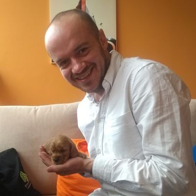 Image of Pete with a puppy